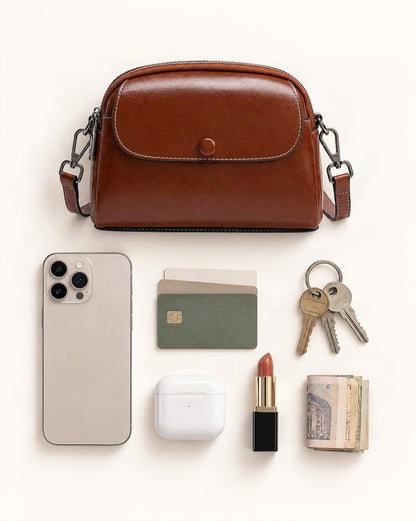 What fits in the Cowhide Mini Crossbody Bag with Snap Flap, Oil-Waxed Leather: smartphone up to 6.9 in, cards, keys, a lipstick, airpods in their case, a few banknotes folded over into a small stack, no complete flat bill face showing