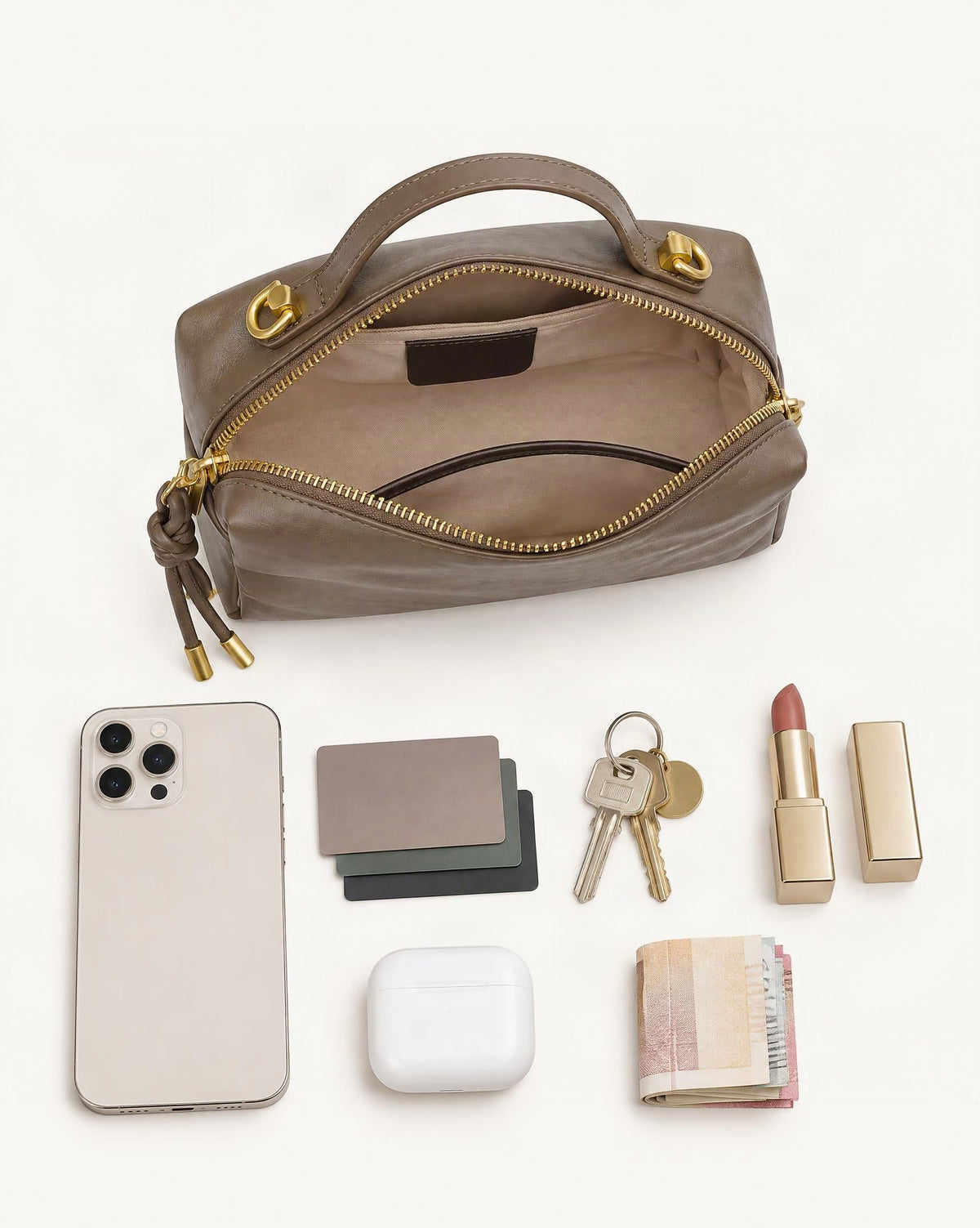 What fits in the Cowhide Leather Small Crossbody Bag: smartphone up to 6.9 in, cards, keys, a lipstick, airpods in their case, a few banknotes folded over into a small stack, no complete flat bill face showing