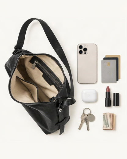 What fits in the Leather Small Plus Shoulder Bag: smartphone up to 6.9 in, cards, keys, a lipstick, airpods in their case, a few banknotes folded over into a small stack, no complete flat bill face showing