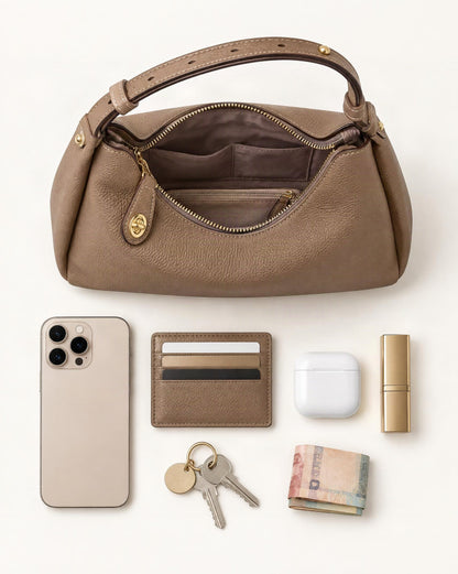 What fits in the Cowhide Leather Small Plus Shoulder Bag: smartphone up to 6.9 in, cards, keys, a lipstick, airpods in their case, a few banknotes folded over into a small stack, no complete flat bill face showing
