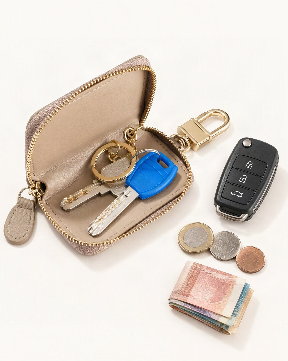 What fits in the Genuine Leather Zip-Around Key Pouch with Carabiner Clip: house keys, a car key fob, coins, a few banknotes folded over into a small stack, no complete flat bill face showing