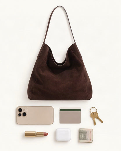 What fits in the Suede Cowhide Slouchy Shoulder Tote Bag: a 6.9-inch phone (iPhone 16 Pro Max), cards, keys, a lipstick, AirPods in their case, folded notes