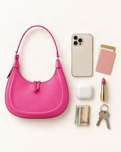 What fits in the Cowhide Crescent Moon Bag: smartphone up to 6.9 in, cards, keys, a lipstick, airpods in their case, a few banknotes folded over into a small stack, no complete flat bill face showing