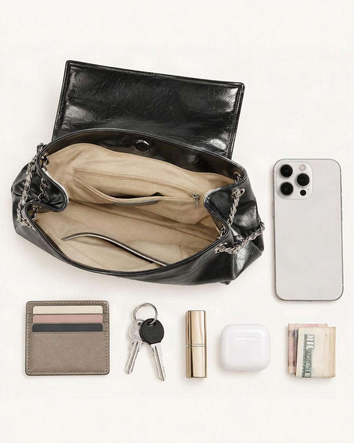 What fits in the Cowhide Leather Soft Chain Shoulder Bag – Horizontal Tote: smartphone up to 6.9 in, cards, keys, a lipstick, airpods in their case, a few banknotes folded over into a small stack, no complete flat bill face showing