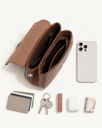 What fits in the Cowhide Leather Mini Crossbody Bag: smartphone up to 6.9 in, cards, keys, a lipstick, airpods in their case, a few banknotes folded over into a small stack, no complete flat bill face showing