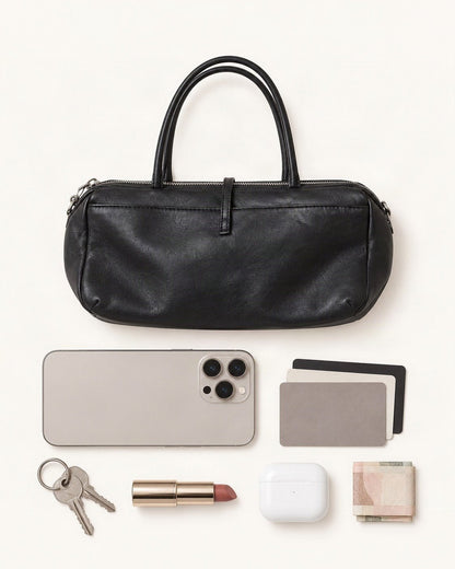 What fits in the Lambskin Small Boston Bag: a 6.9-inch phone (iPhone 16 Pro Max), cards, keys, a lipstick, AirPods in their case, folded notes