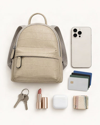What fits in the Top-Grain Cowhide Small Backpack: smartphone up to 6.9 in, cards, keys, a lipstick, airpods in their case, a few banknotes folded over into a small stack, no complete flat bill face showing