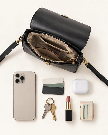 What fits in the Cowhide Leather Small Crossbody Bag with Turn-Lock Closure: smartphone up to 6.9 in, cards, keys, a lipstick, airpods in their case, a few banknotes folded over into a small stack, no complete flat bill face showing