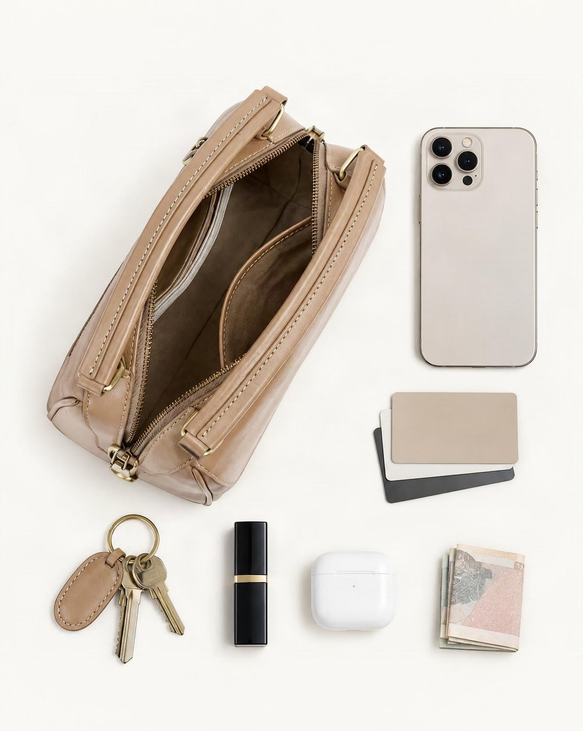 What fits in the Cowhide Leather Boston Shoulder Bag: smartphone up to 6.9 in, cards, keys, a lipstick, airpods in their case, a few banknotes folded over into a small stack, no complete flat bill face showing
