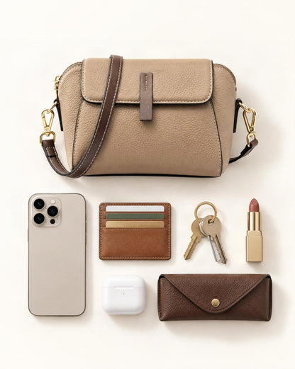 What fits in the Cowhide Small Shell Crossbody Bag: smartphone up to 6.9 in, cards, keys, a lipstick, airpods in their case, sunglasses in a slim case