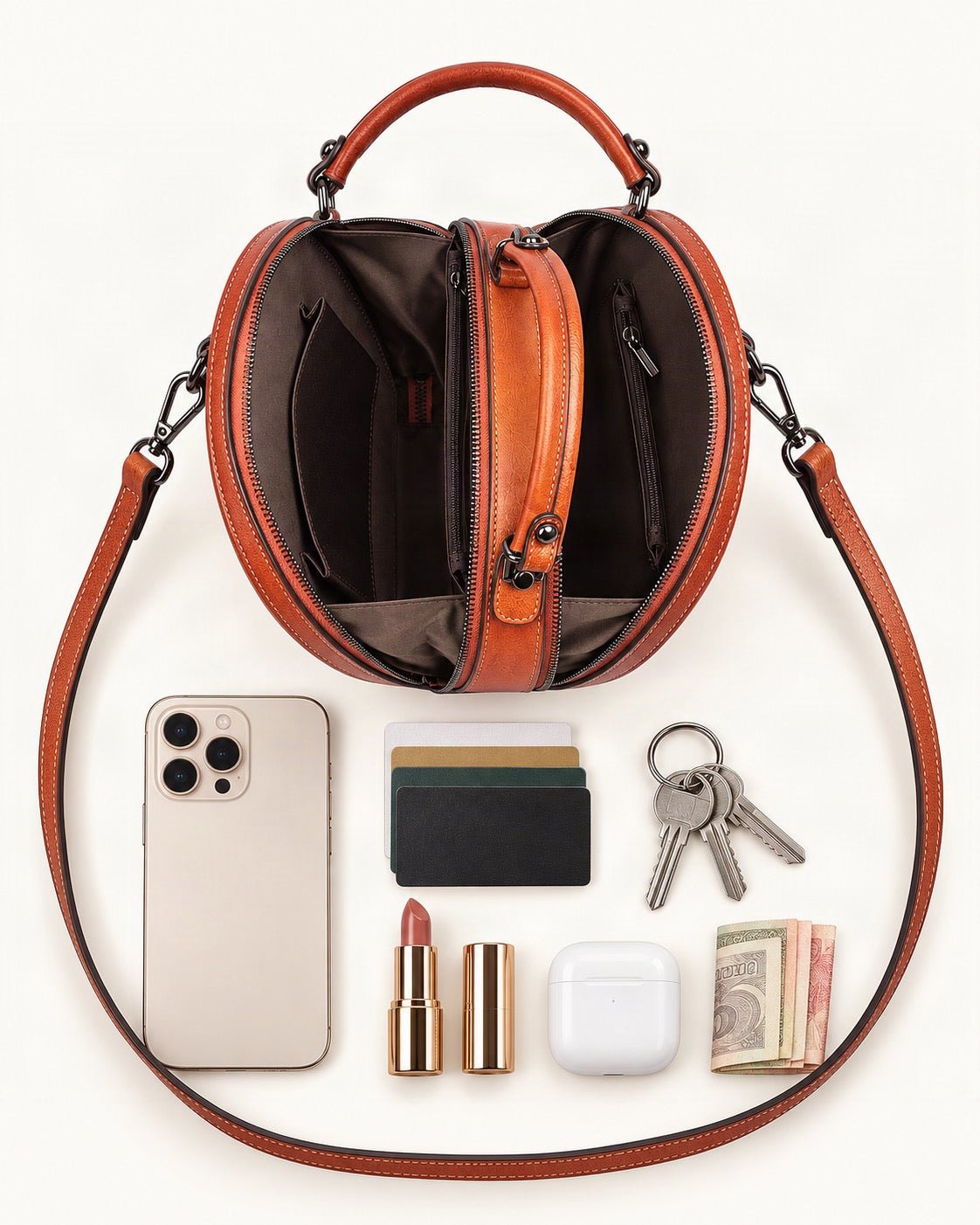 What fits in the Top-Grain Cowhide Round Crossbody Bag: smartphone up to 6.9 in, cards, keys, a lipstick, airpods in their case, a few banknotes folded over into a small stack, no complete flat bill face showing