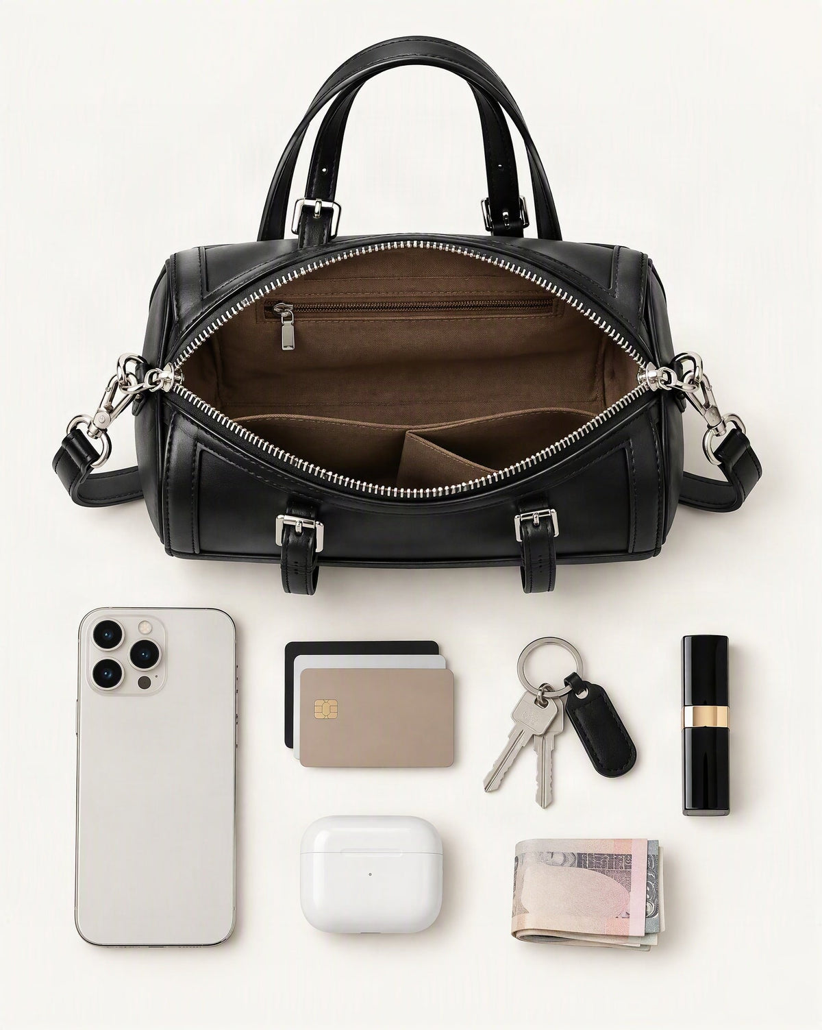 What fits in the Cowhide Leather Mini Boston Bowling Bag: smartphone up to 6.9 in, cards, keys, a lipstick, airpods in their case, a few banknotes folded over into a small stack, no complete flat bill face showing