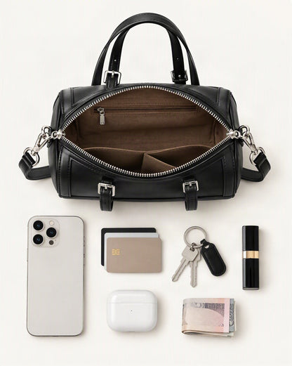 What fits in the Cowhide Leather Mini Boston Bowling Bag: smartphone up to 6.9 in, cards, keys, a lipstick, airpods in their case, a few banknotes folded over into a small stack, no complete flat bill face showing