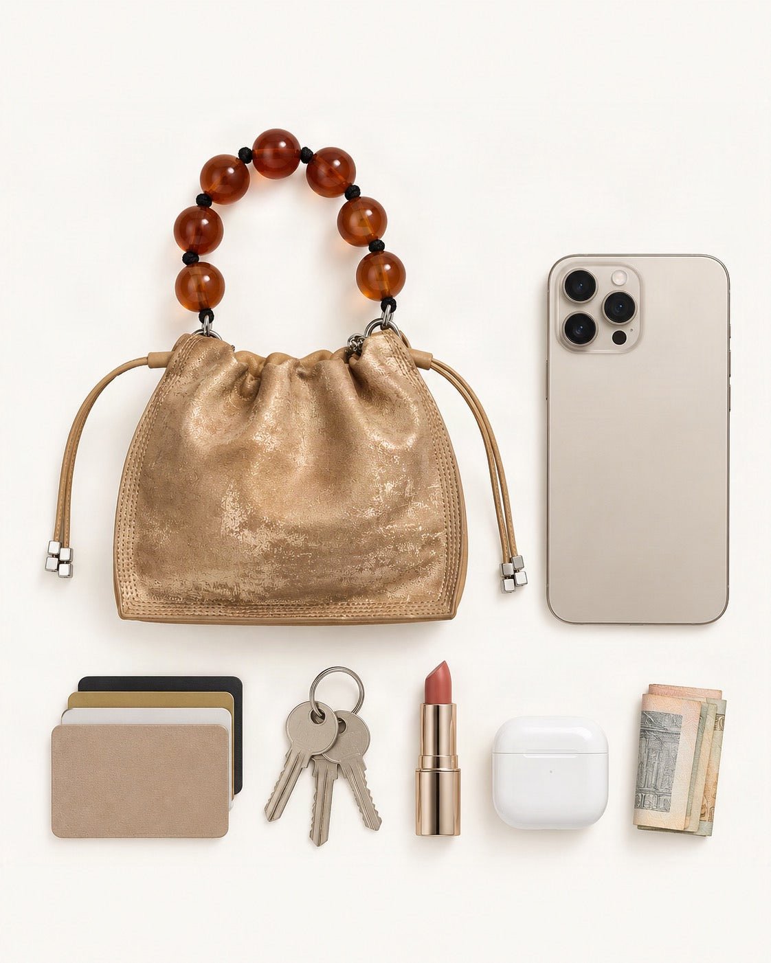 What fits in the Cowhide Mini Bucket Bag Crossbody Drawstring Bead Handle: smartphone up to 6.9 in, cards, keys, a lipstick, airpods in their case, a few banknotes folded over into a small stack, no complete flat bill face showing