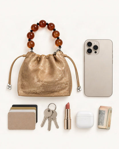 What fits in the Cowhide Mini Bucket Bag Crossbody Drawstring Bead Handle: smartphone up to 6.9 in, cards, keys, a lipstick, airpods in their case, a few banknotes folded over into a small stack, no complete flat bill face showing