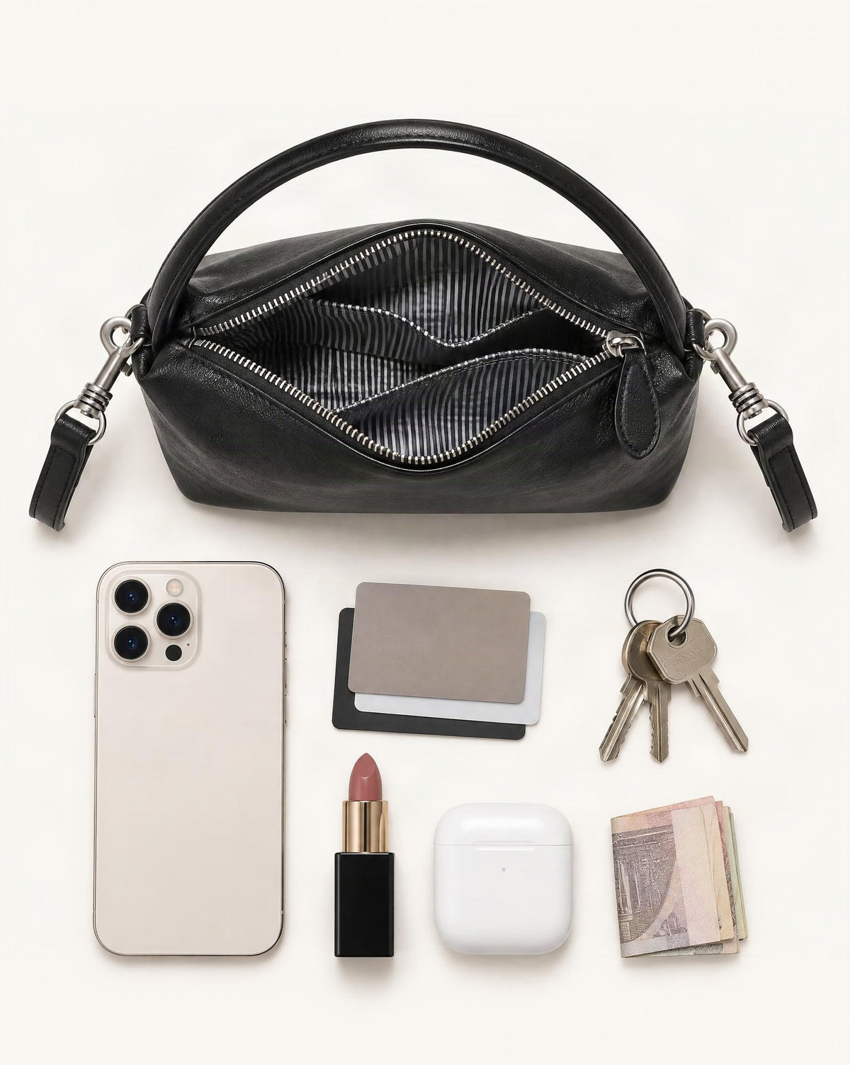 What fits in the Top-Grain Cowhide Pillow Bag with Detachable Strap: smartphone up to 6.9 in, cards, keys, a lipstick, airpods in their case, a few banknotes folded over into a small stack, no complete flat bill face showing