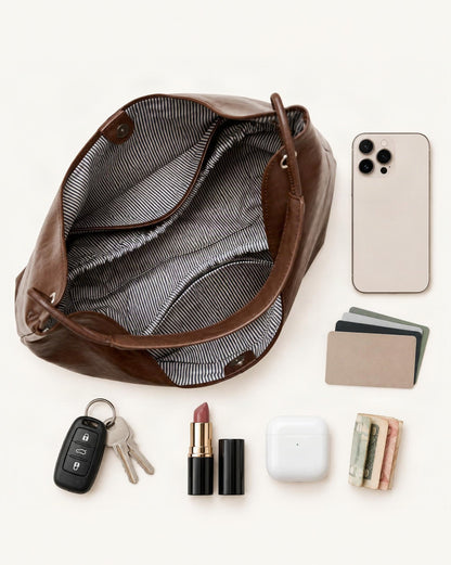 What fits in the Cowhide Leather Small Hobo Shoulder Bag: smartphone up to 6.9 in, cards, keys, a lipstick, airpods in their case, a few banknotes folded over into a small stack, no complete flat bill face showing