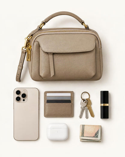 What fits in the Top-Grain Cowhide Boston Crossbody Bag: smartphone up to 6.9 in, cards, keys, a lipstick, airpods in their case, a few banknotes folded over into a small stack, no complete flat bill face showing