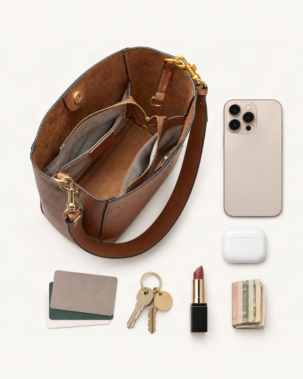 What fits in the Cowhide Leather Small Bucket Tote Bag: smartphone up to 6.9 in, cards, keys, a lipstick, airpods in their case, a few banknotes folded over into a small stack, no complete flat bill face showing