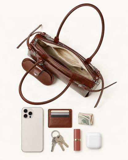 What fits in the Cowhide Leather Small Barrel Tote with Sunglass Pouch: smartphone up to 6.9 in, cards, keys, a lipstick, airpods in their case, a few banknotes folded over into a small stack, no complete flat bill face showing