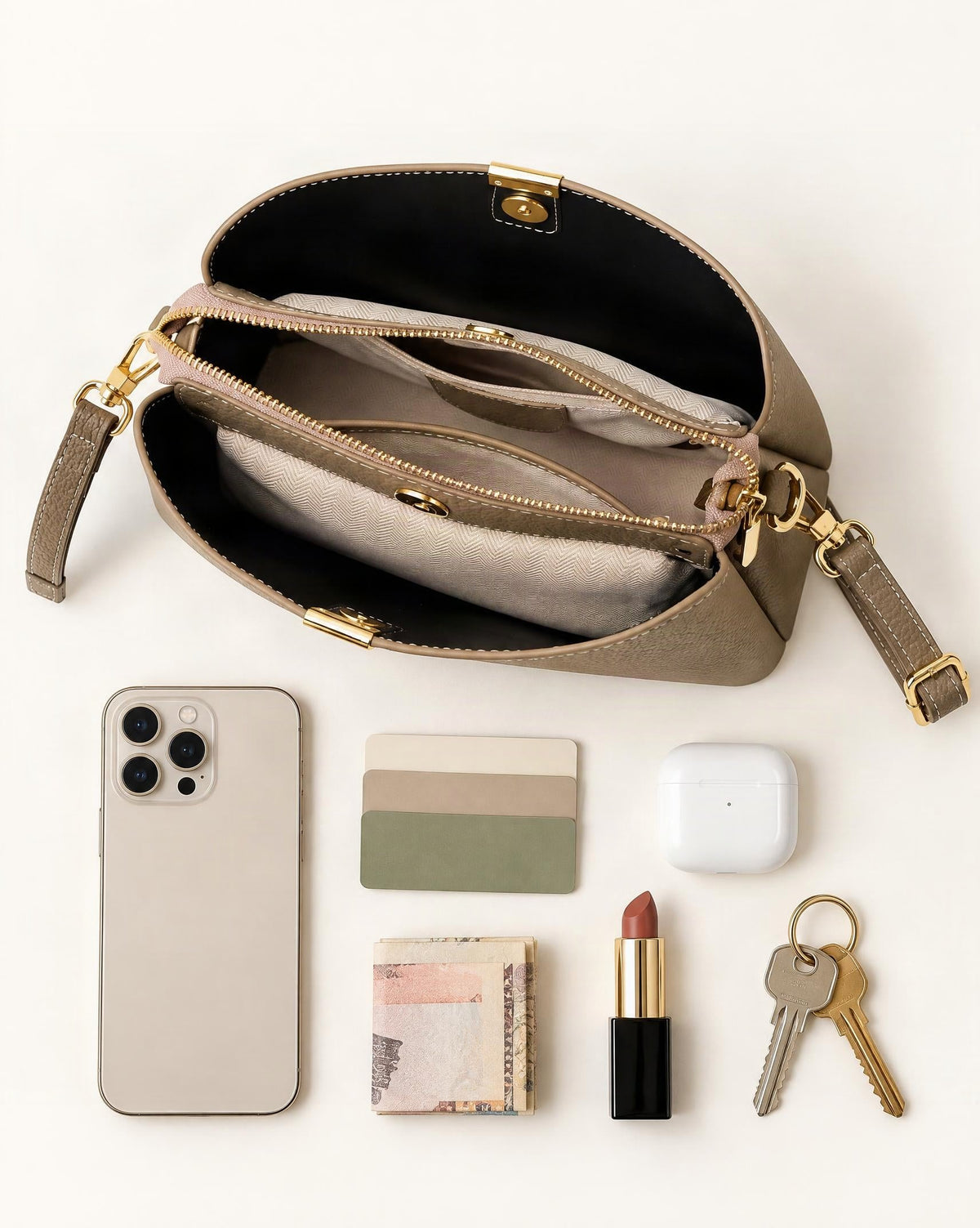 What fits in the Cowhide Leather Crescent Bucket Bag: smartphone up to 6.9 in, cards, keys, a lipstick, airpods in their case, a few banknotes folded over into a small stack, no complete flat bill face showing