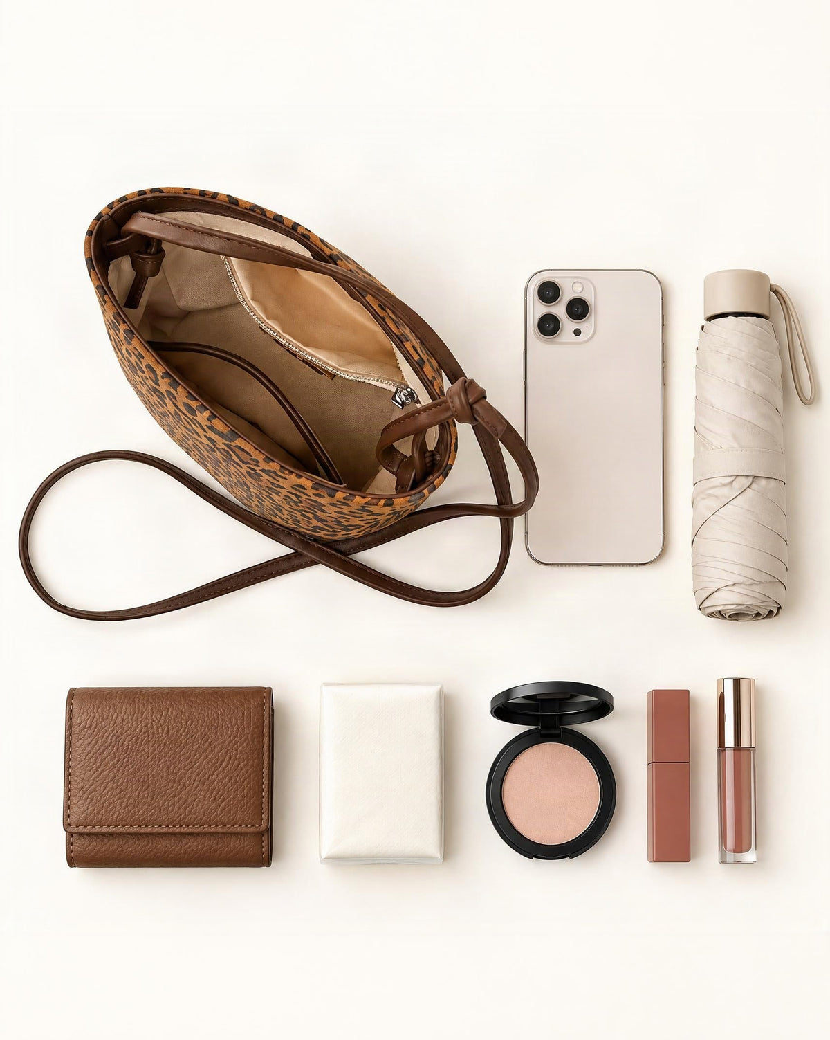 What fits in the Nubuck Cowhide Bucket Crossbody Bag: smartphone up to 6.5 in, a short wallet, a compact umbrella up to 7 in (18 cm), pocket tissues, makeup essentials
