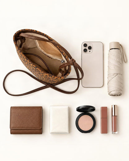What fits in the Nubuck Cowhide Bucket Crossbody Bag: smartphone up to 6.5 in, a short wallet, a compact umbrella up to 7 in (18 cm), pocket tissues, makeup essentials