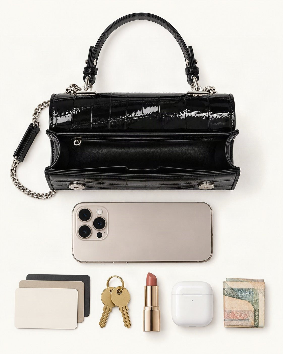 What fits in the Crocodile-Embossed Cowhide Leather Envelope Crossbody Bag: a 6.9-inch phone (iPhone 16 Pro Max), cards, keys, a lipstick, AirPods in their case, folded notes