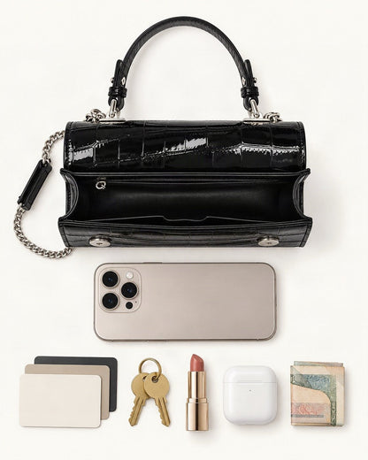 What fits in the Crocodile-Embossed Cowhide Leather Envelope Crossbody Bag: a 6.9-inch phone (iPhone 16 Pro Max), cards, keys, a lipstick, AirPods in their case, folded notes