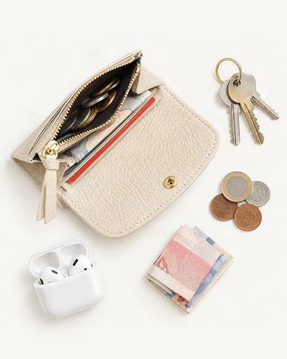 What fits in the Cowhide Mini Coin Purse Wallet with RFID Card Slots: keys, coins, a few banknotes folded over into a small stack, no complete flat bill face showing, earbuds