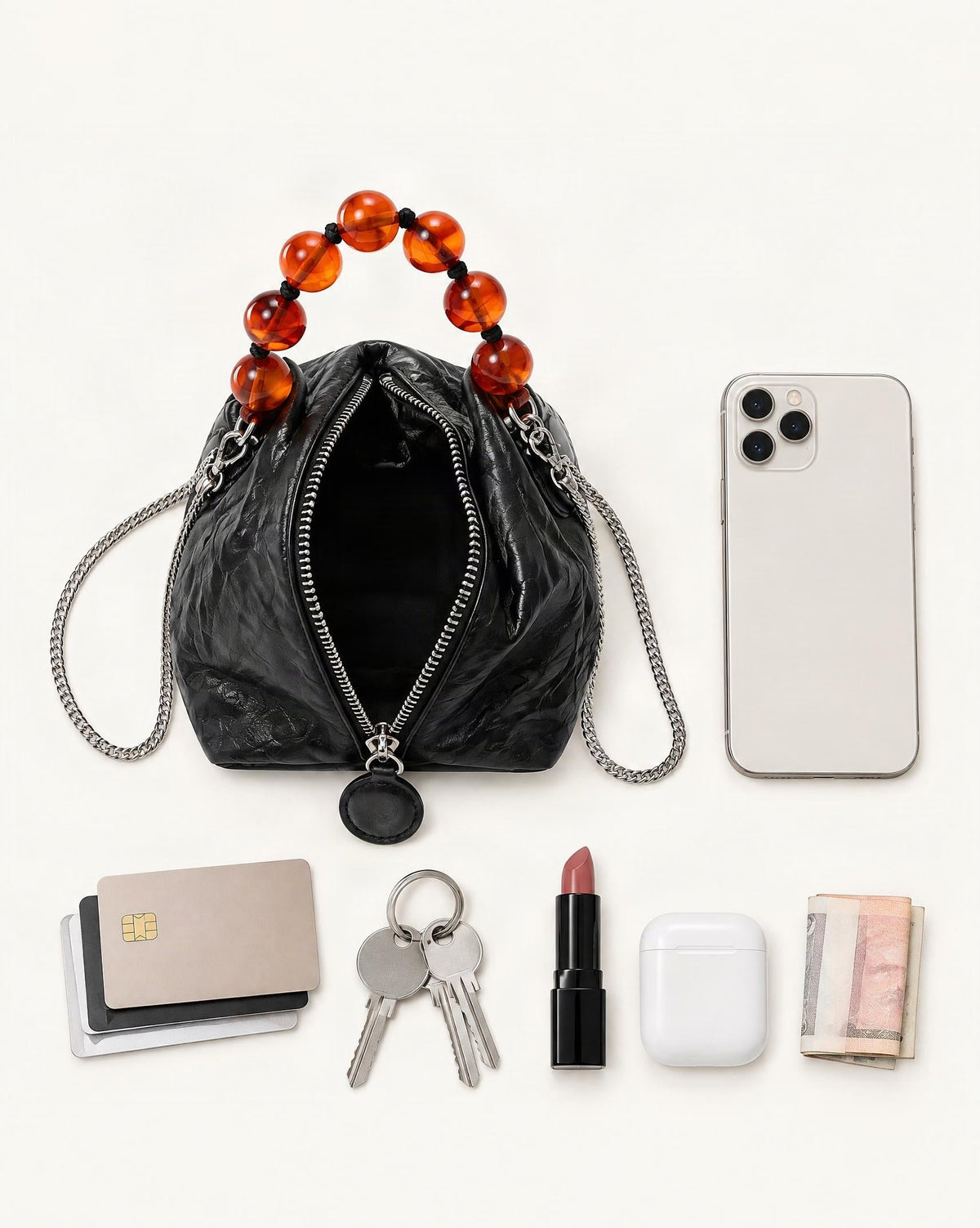 What fits in the Crinkle Cowhide Mini Crossbody Bag with Beaded Handle: smartphone up to 6.3 in, cards, keys, a lipstick, airpods in their case, a few banknotes folded over into a small stack, no complete flat bill face showing