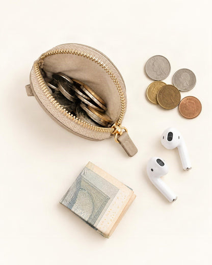 What fits in the Cowhide Leather Mini Round Zip Pouch: coins, earbuds without a case, a folded note