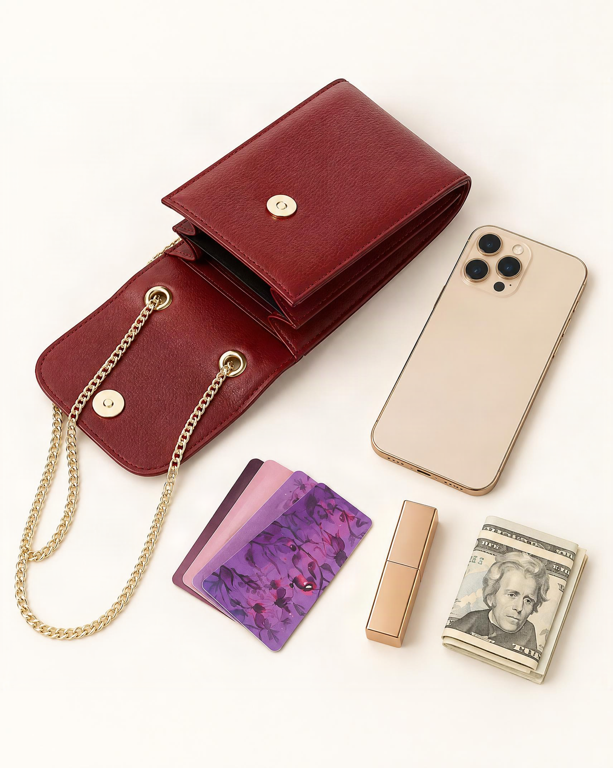 What fits in the Top-Grain Cowhide Micro Crossbody Phone Bag with Chain Strap: a 6.9-inch phone (iphone 16 pro max), several cards, a lipstick, a few banknotes folded over into a small stack, no complete flat bill face showing