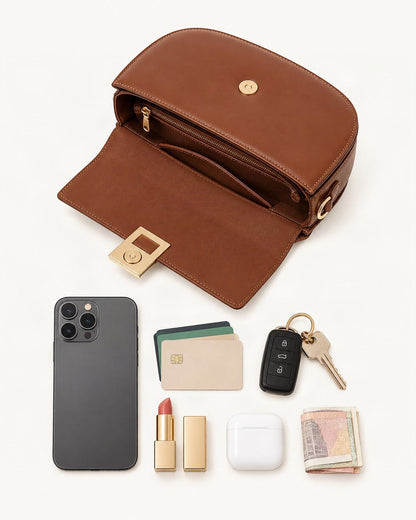 What fits in the Cowhide Mini Saddle Crossbody Bag: smartphone up to 6.9 in, cards, keys, a lipstick, airpods in their case, a few banknotes folded over into a small stack, no complete flat bill face showing