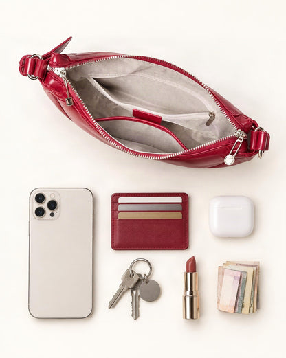 What fits in the Cowhide Leather Crescent Shoulder Bag: smartphone up to 6.9 in, cards, keys, a lipstick, airpods in their case, a few banknotes folded over into a small stack, no complete flat bill face showing