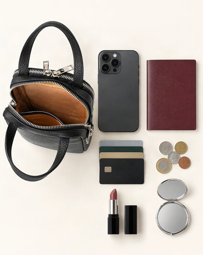 What fits in the Cowhide Leather Vertical Phone Crossbody Bag – Color Options: smartphone up to 6.9 in, a passport, cards, coins, a lipstick, a compact mirror