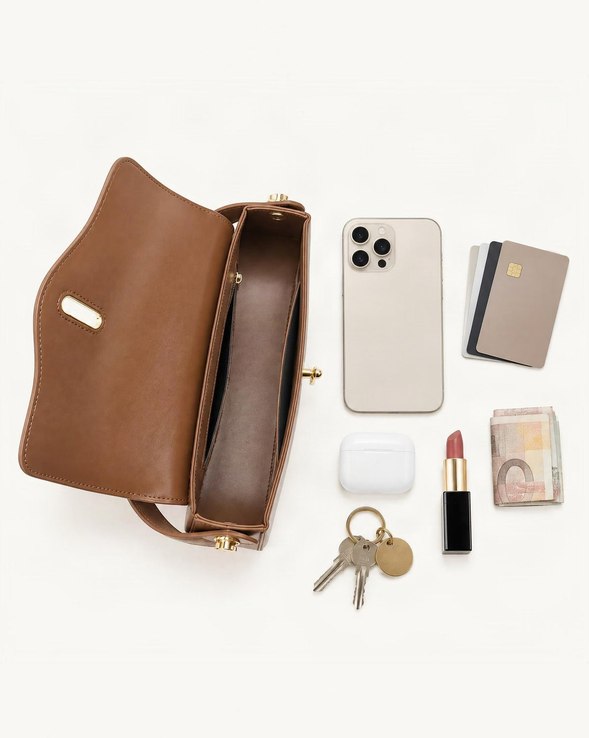 What fits in the Cowhide Leather Baguette Crossbody Shoulder Top Handle: smartphone up to 6.9 in, cards, keys, a lipstick, airpods in their case, a few banknotes folded over into a small stack, no complete flat bill face showing