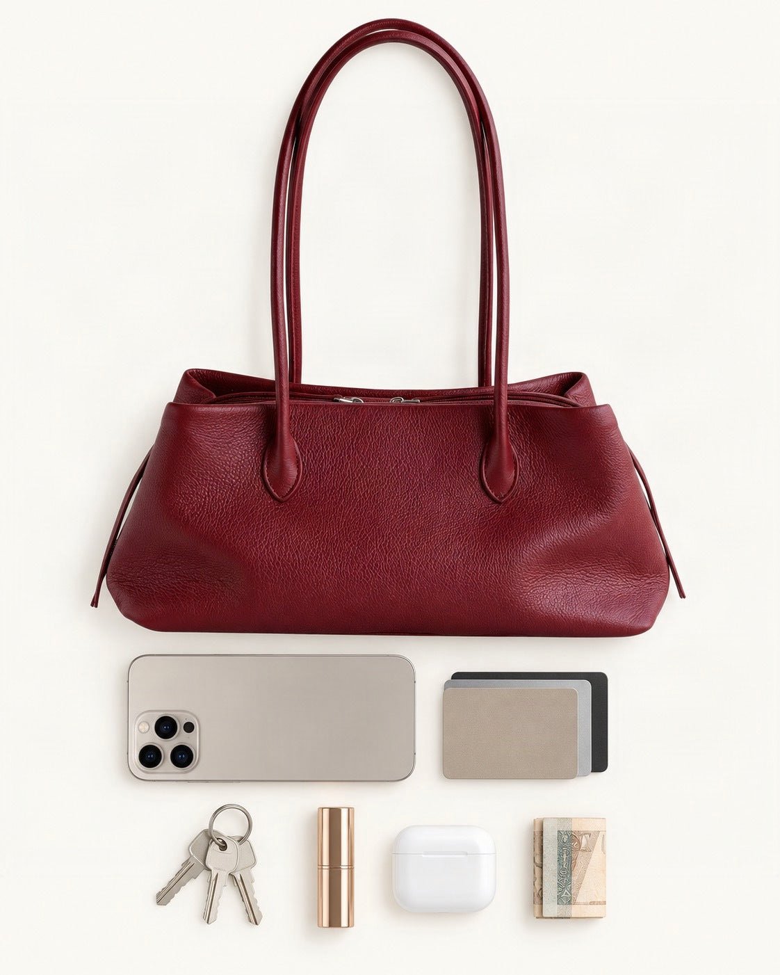 What fits in the Top-Grain Cowhide Shoulder Tote: a 6.9-inch phone (iPhone 16 Pro Max), cards, keys, a lipstick, AirPods in their case, folded notes