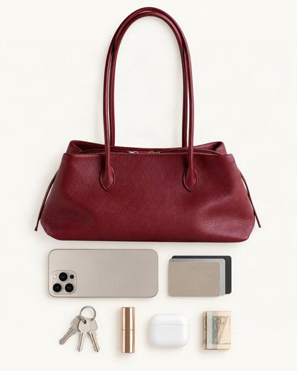 What fits in the Top-Grain Cowhide Shoulder Tote: a 6.9-inch phone (iPhone 16 Pro Max), cards, keys, a lipstick, AirPods in their case, folded notes