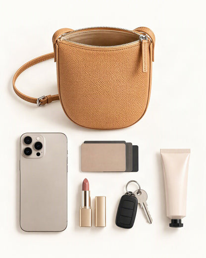 What fits in the Cowhide Leather Mini Crossbody Phone Bag: a 6.9-inch phone (iphone 16 pro max), cards, a lipstick, keys, a 50 ml hand cream