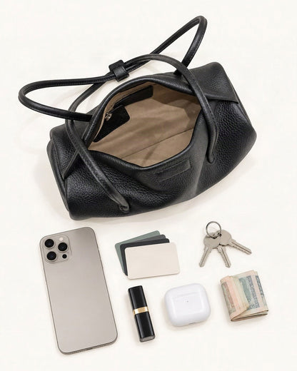 What fits in the Top-Grain Cowhide Pillow Shoulder Bag: a 6.9-inch phone (iPhone 16 Pro Max), cards, keys, a lipstick, AirPods in their case, folded notes
