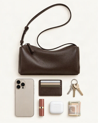 What fits in the Cowhide Leather Small Barrel Crossbody Bag: smartphone up to 6.9 in, cards, keys, a lipstick, airpods in their case, a few banknotes folded over into a small stack, no complete flat bill face showing