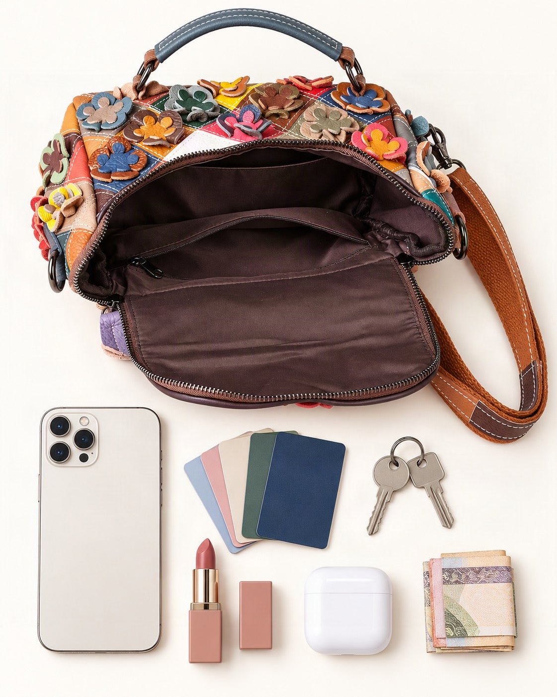 What fits in the Top-Grain Cowhide Small Crossbody Bag: smartphone up to 6.9 in, cards, keys, a lipstick, airpods in their case, a few banknotes folded over into a small stack, no complete flat bill face showing
