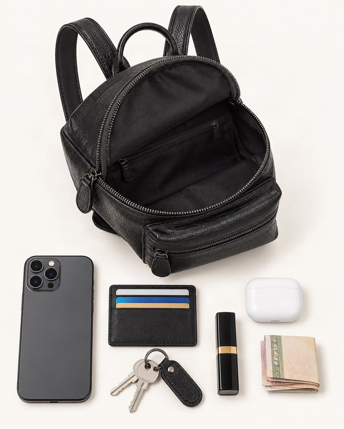 What fits in the Split Leather Mini Backpack: smartphone up to 6.9 in, cards, keys, a lipstick, airpods in their case, a few banknotes folded over into a small stack, no complete flat bill face showing