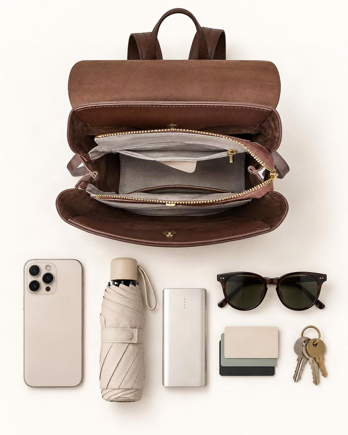 What fits in the Cowhide Leather Backpack with Magnetic Flap: smartphone up to 6.9 in, a compact umbrella, a slim power bank, sunglasses, cards, keys